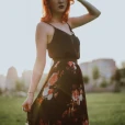 body shot of woman wearing a dress at dusk