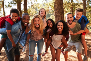 A photo of friends and family smiling for a picture.